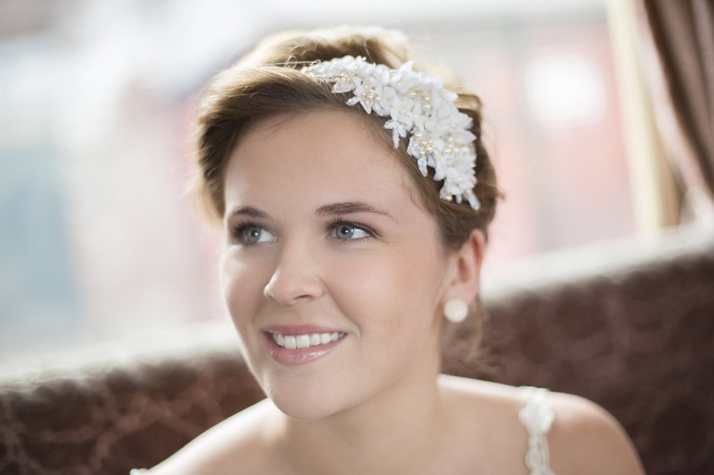 Photo Bridesmaid wearing vintage couture headpiece with pearls and laces